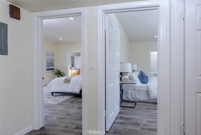 hallway with dark hardwood / wood-style floors and electric panel