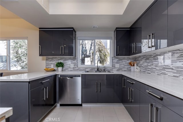 kitchen with dishwasher, decorative backsplash, plenty of natural light, and sink