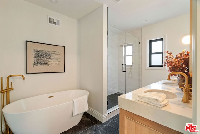 bathroom featuring vanity and independent shower and bath