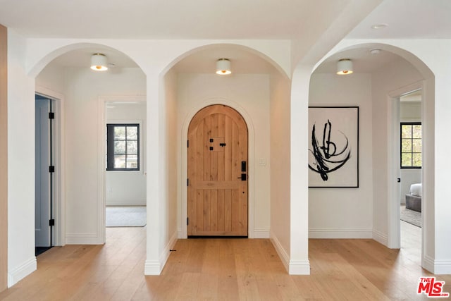 entryway featuring a healthy amount of sunlight and light hardwood / wood-style floors