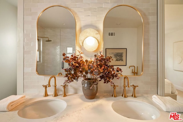 interior details featuring decorative backsplash, vanity, and tiled shower