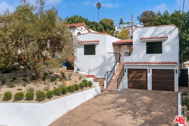 mediterranean / spanish house with a garage