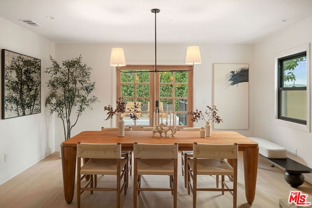 dining room with french doors and light wood-type flooring