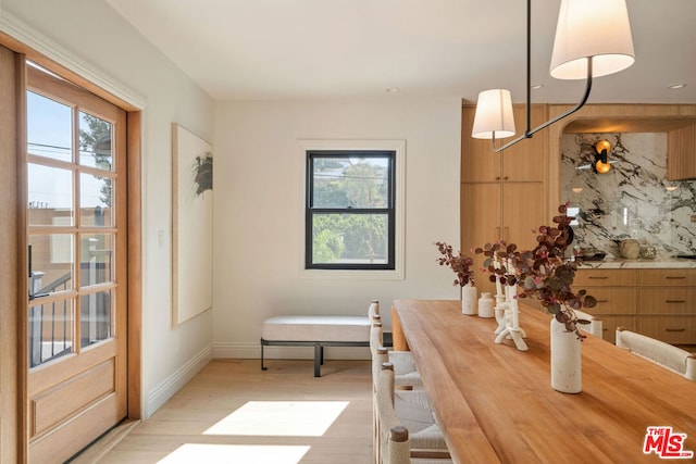 dining space with light hardwood / wood-style floors