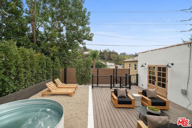 exterior space featuring an outdoor living space and a jacuzzi