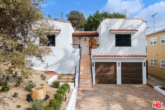 mediterranean / spanish house with a garage