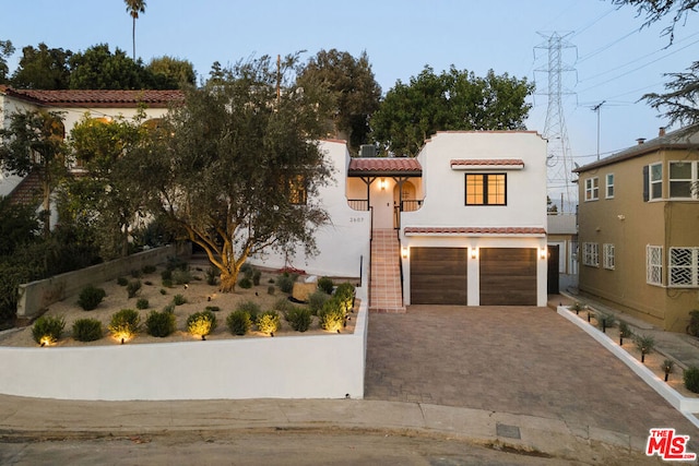 mediterranean / spanish-style home with a garage