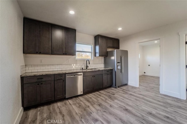 kitchen featuring dark brown cabinets, sink, stainless steel appliances, and light hardwood / wood-style flooring