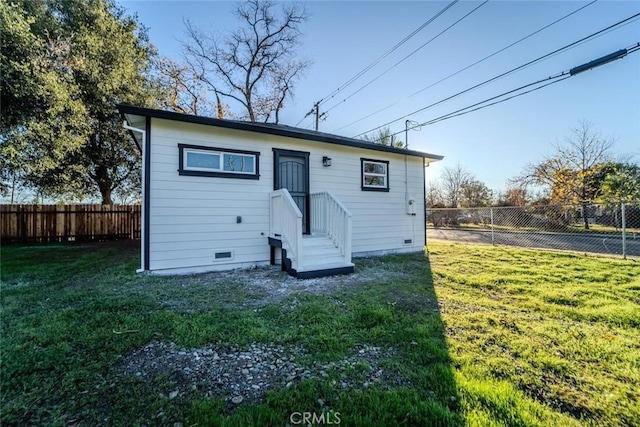 back of house with a lawn