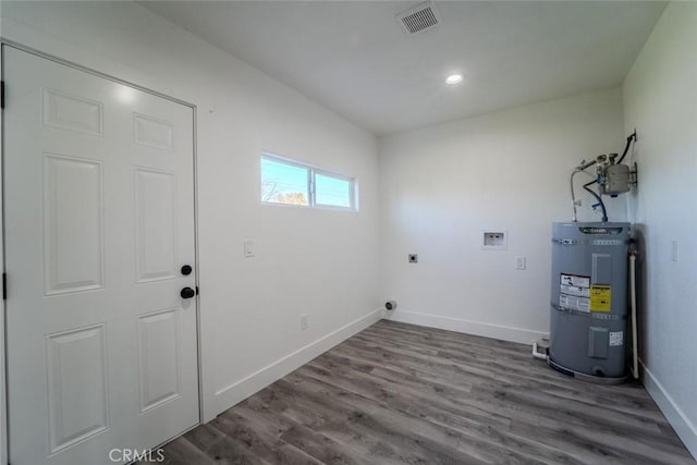 laundry area with hookup for a washing machine, water heater, hardwood / wood-style floors, and hookup for an electric dryer