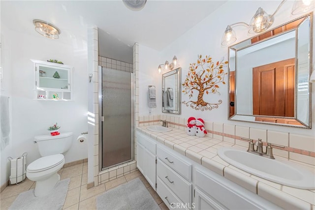 bathroom featuring a shower with shower door, tile patterned floors, toilet, and vanity