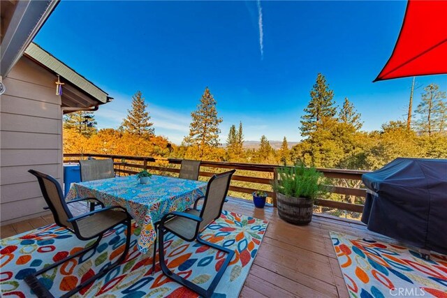 wooden terrace featuring grilling area