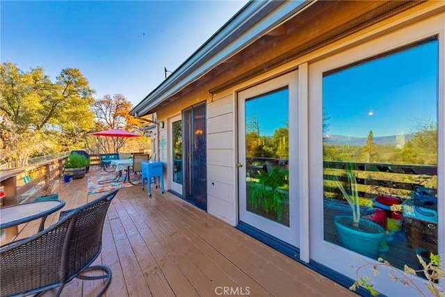 wooden deck with outdoor dining space