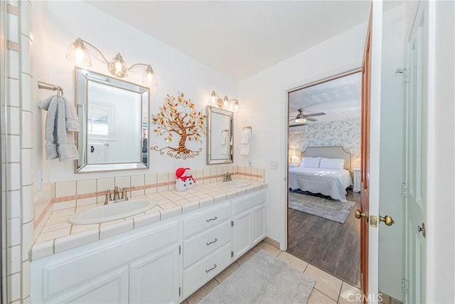 bathroom with ceiling fan, tile patterned floors, and vanity