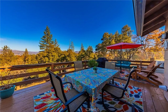 wooden terrace with outdoor dining area