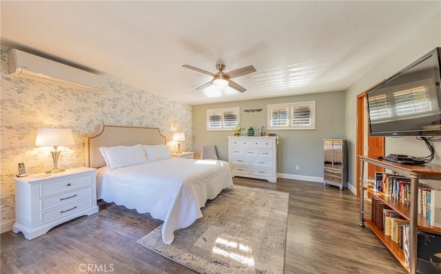 bedroom with wallpapered walls, baseboards, a ceiling fan, wood finished floors, and a wall mounted air conditioner