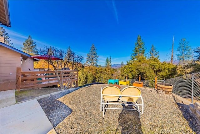 view of yard featuring fence and a deck