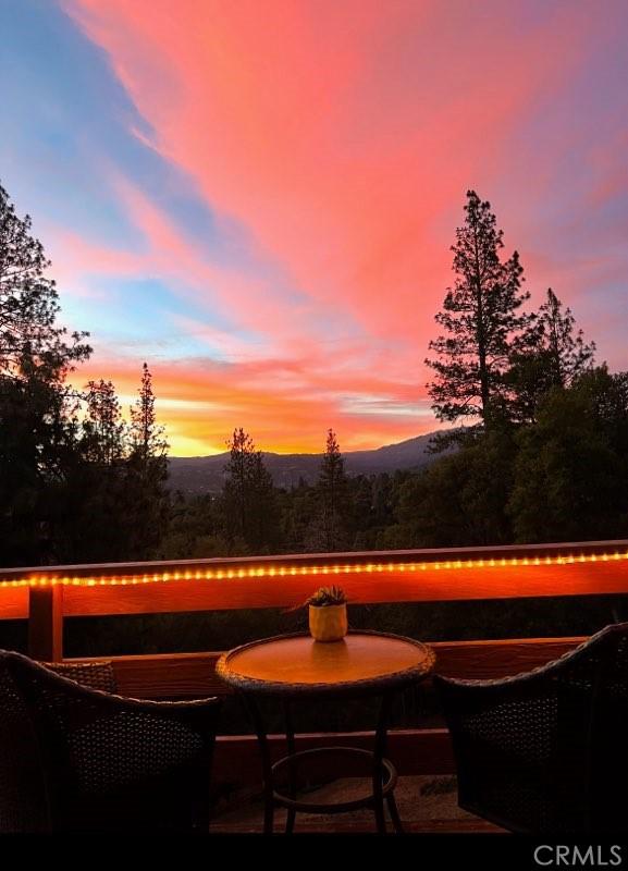 patio terrace at dusk featuring a mountain view