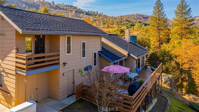 rear view of house with a balcony and a patio