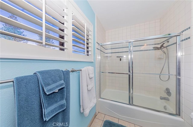 full bathroom with tile patterned flooring and combined bath / shower with glass door