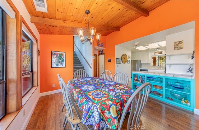 dining area with wooden ceiling, visible vents, stairway, and wood finished floors