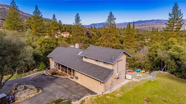 aerial view featuring a mountain view and a wooded view