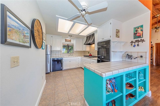 kitchen with open shelves, black appliances, wall chimney exhaust hood, and white cabinetry