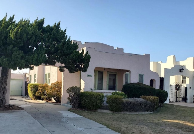 adobe home with a front lawn