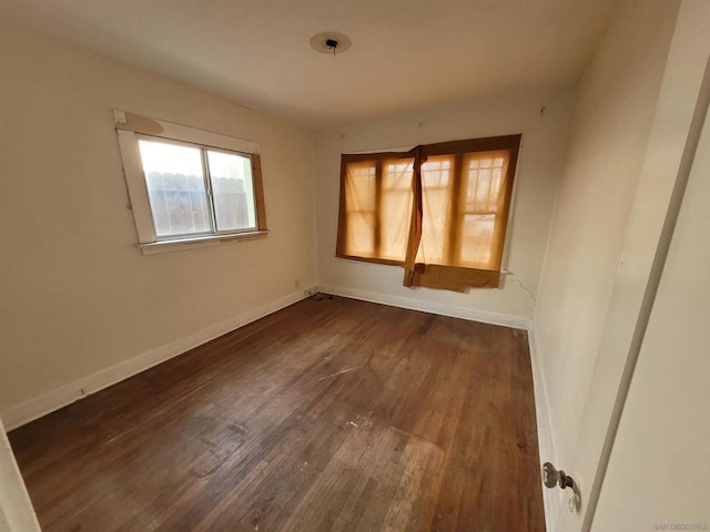 unfurnished room with dark hardwood / wood-style floors