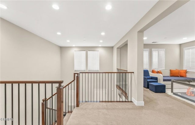 hallway featuring light carpet