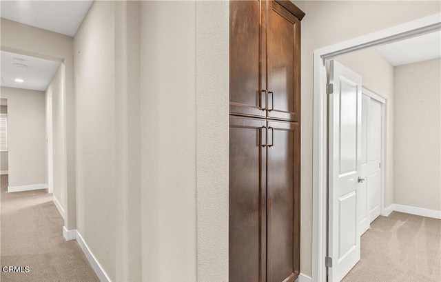 corridor with light colored carpet