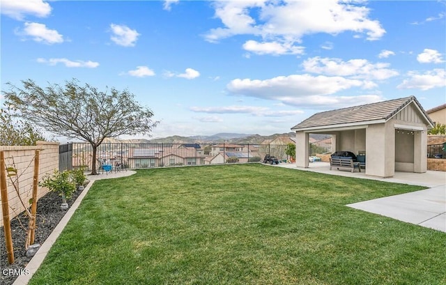 view of yard featuring a patio area and a mountain view