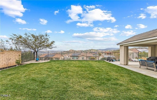 view of yard featuring a mountain view and a patio