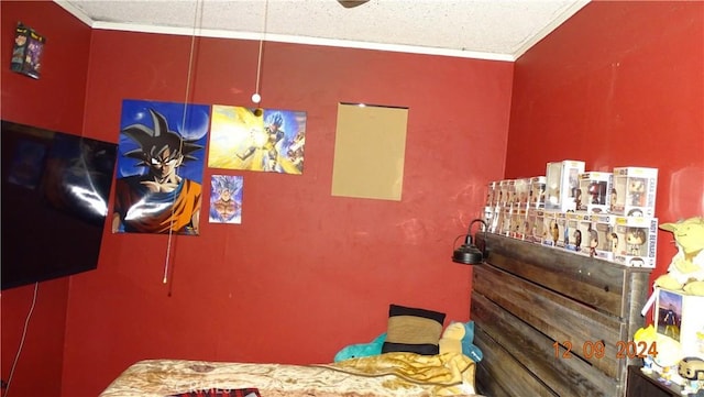 bedroom with a textured ceiling and ornamental molding