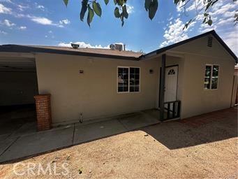 back of property featuring a carport