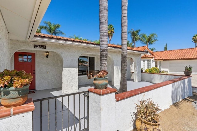 mediterranean / spanish house with covered porch