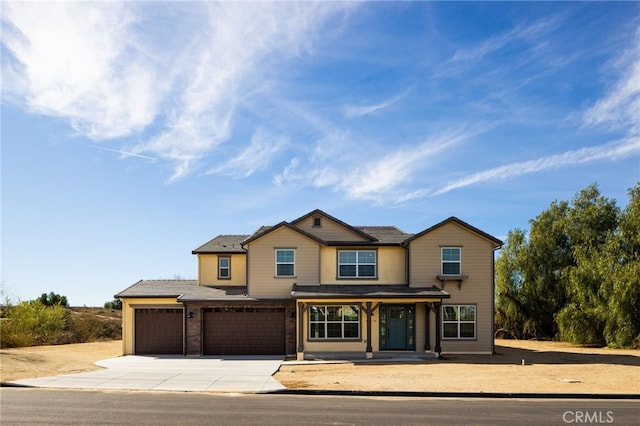 view of front of property featuring driveway and a garage