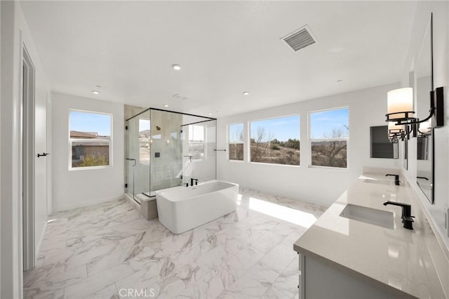 full bath featuring a wealth of natural light, marble finish floor, visible vents, and a sink