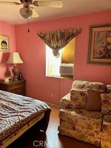 bedroom featuring wood-type flooring, ceiling fan, and cooling unit