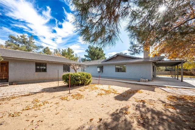 view of home's exterior featuring a carport