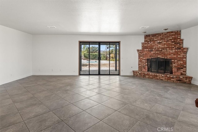 unfurnished living room with a brick fireplace