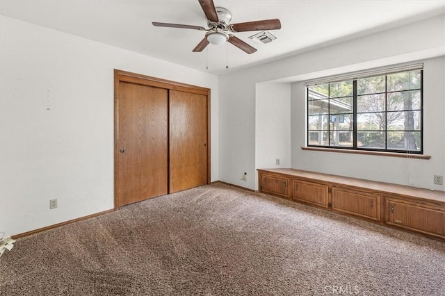 unfurnished bedroom with ceiling fan, light colored carpet, and a closet