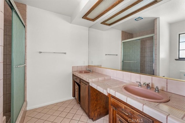 bathroom featuring vanity, an enclosed shower, and tile patterned flooring