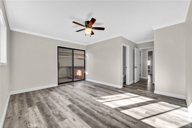 empty room featuring hardwood / wood-style floors, ceiling fan, and ornamental molding