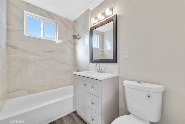 full bathroom with vanity, hardwood / wood-style flooring, toilet, and tiled shower / bath