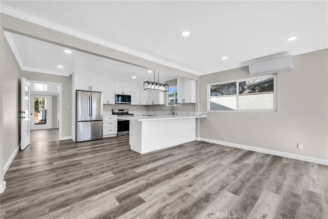 kitchen featuring an AC wall unit, white cabinets, light hardwood / wood-style floors, and appliances with stainless steel finishes