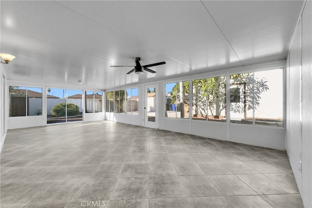 unfurnished sunroom with plenty of natural light and ceiling fan