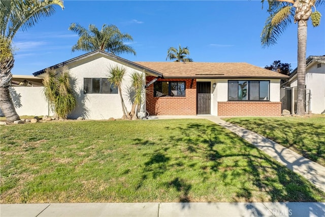 single story home featuring a front lawn