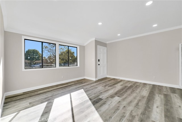 unfurnished room with light hardwood / wood-style floors and ornamental molding