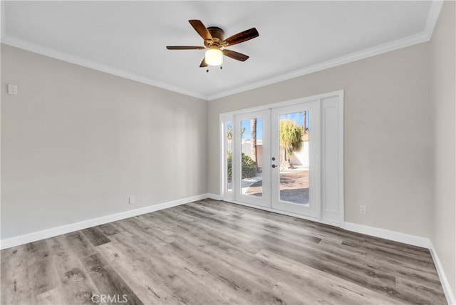 unfurnished room featuring french doors, ornamental molding, and light hardwood / wood-style flooring